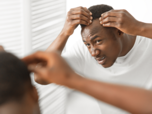 Black guy checking for lice